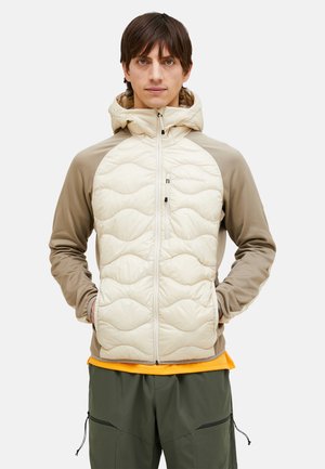 Polstret jakke med en beige kviltet front, beige ærmer og hætte. Har en lynlåslukning og et struktureret mønster på forsiden.