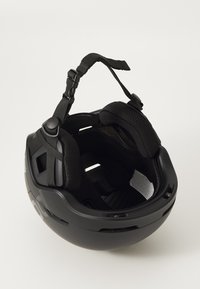 Czarny kask rowerowy z gładką powłoką zewnętrzną, regulowanym paskiem podszytym na podbródku, wyściełanym wnętrzem oraz otworami wentylacyjnymi. Wnętrze posiada chropowatą wyściółkę.