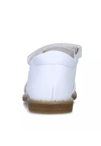 Sandalo in pelle bianca con una fascia testurizzata, retro chiuso e suola in gomma color tan. Include un accento con fibbia argentata.