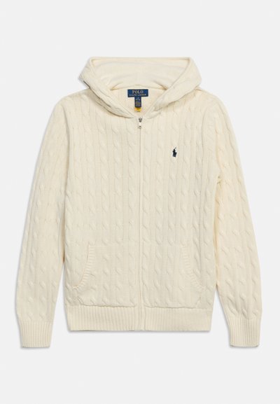 Κρεμ χρωματισμένο πλεκτό hoodie με φερμουάρ, μπροστινές τσέπες και μικρό σκούρο μπλε λογότυπο Polo Ralph Lauren στο στήθος.