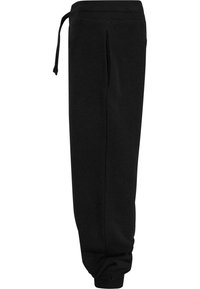 Pantalons de survêtement noirs avec une taille élastique et un cordon de serrage, des poignets ajustés et une texture de tissu lisse. Design minimaliste sans motifs.