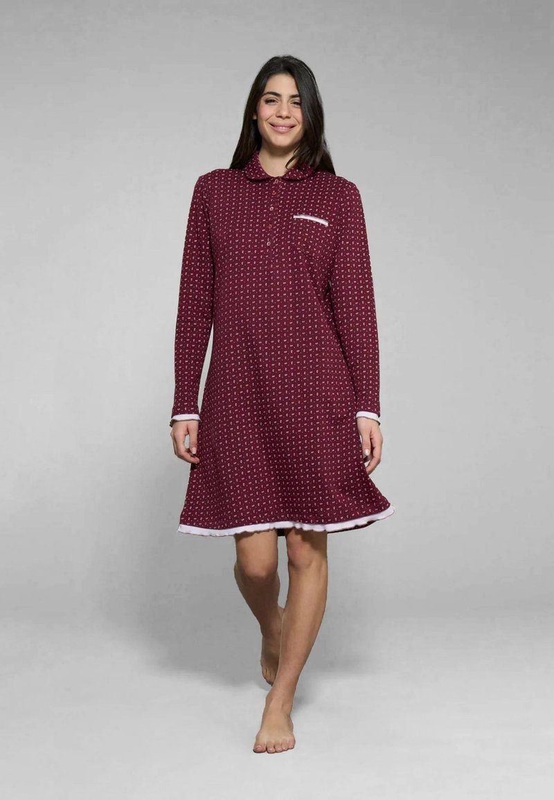 Camicetta burdeos con maniche lunghe, colletto e dettagli bianchi. Motivo a pois, lunghezza al ginocchio, realizzata in tessuto morbido, con una piccola tasca.