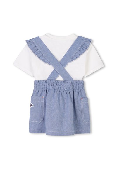 Denim tuinbroek jurk met gerimpelde blauwe schouderbanden over een wit T-shirt. Voorzien van een elastische taille en twee zakken met contrasterende stiksels.
