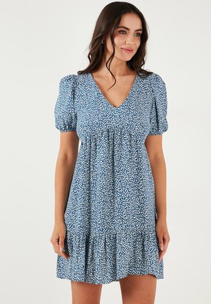 Blue floral print dress with short puff sleeves, a V-neckline, and a tiered ruffled hem. Made from lightweight fabric, features a loose fit.