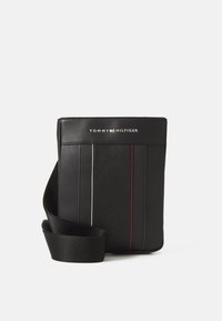 Black leather crossbody bag with textured surface, featuring vertical stripes in red, white, and blue, and a shoulder strap. Logo displayed on front.