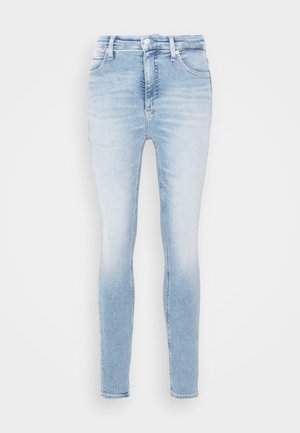 Light blue skinny jeans in faded denim, featuring a high-rise waist, five pockets, and a standard button-and-zip fly closure.