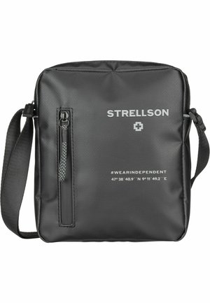 Black synthetic messenger bag with a textured finish, front zip pocket, adjustable strap, and printed details including brand logo and coordinates.