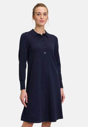 Abito polo blu navy a maniche lunghe realizzato in tessuto morbido. Presenta un colletto, una patta con bottoni e una gonna svasata per un fit rilassato.
