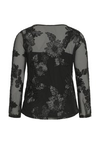 Haut noir transparent à manches longues avec des motifs floraux brodés et un panneau noir uni couvrant la partie avant du torse.
