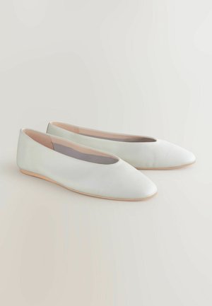 Ploché topánky z jemnej sivej kože s ostrou špičkou a minimalistickým dizajnom. Mäkkučké podšívky a hnedá gumová podrážka. Bez viditeľných ozdôb.