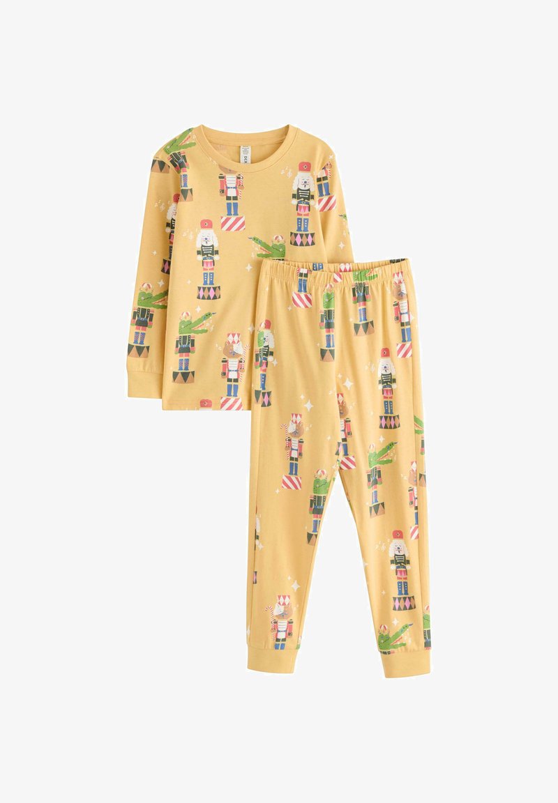 Ensemble de pyjama à manches longues jaunes avec des motifs de casse-noisette et de fête. Comprend un pantalon à taille élastique assorti. Matériau en coton doux.