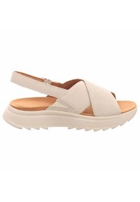 Sandale beige clair avec un design à brides croisées, dessus texturé, semelle intérieure rembourrée et une épaisse semelle blanche striée. Bride ajustable arrière.