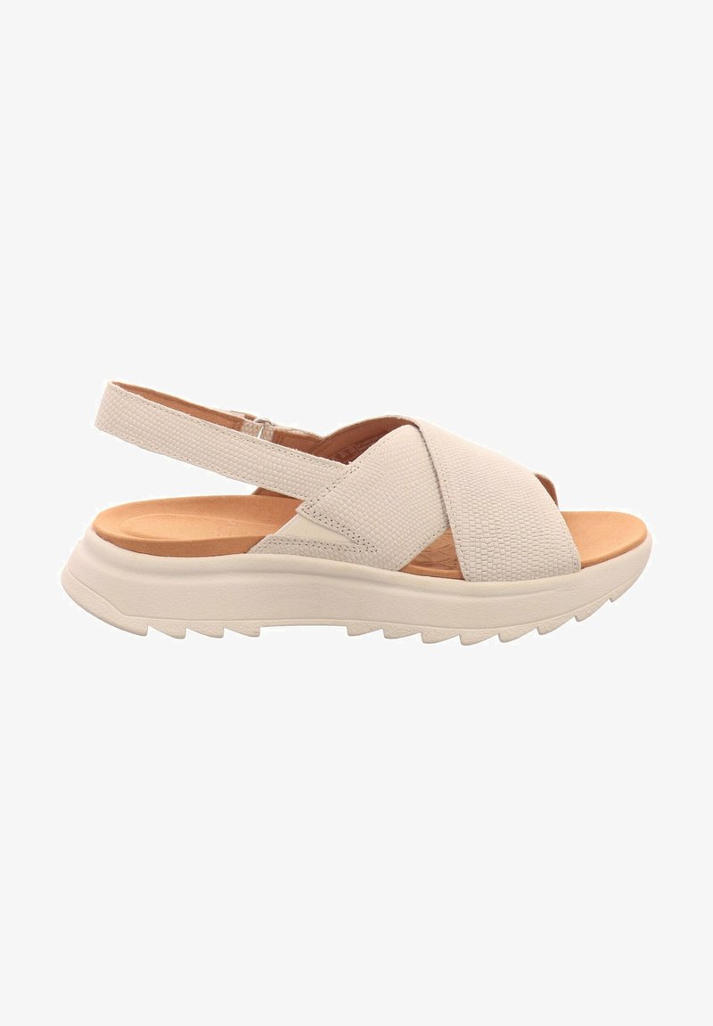 Hellbeige Sandale mit Kreuzriemen-Design, strukturierter Oberseite, gepolstertem Fußbett und einer dicken, geriffelten weißen Sohle. Verstellbarer Ferse-Riemen.