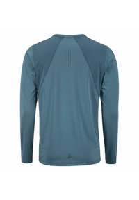 Langärmliges Hemd aus blau-grauem Stoff, mit Rundhalsausschnitt, Mesh-Details an den Schultern und kleinen Belüftungslöchern am Rücken.