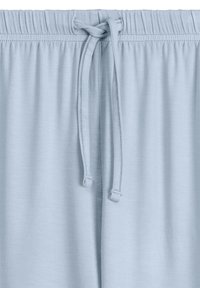Jasnoniebieskie spodnie lounges w miękkim materiale. Posiadają elastyczny pas z sznurkiem do regulacji. Gładka faktura, brak wzorów.