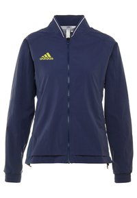 Navy blue Adidas zip-up jacket with yellow logo, high collar, long sleeves, and elastic cuffs.