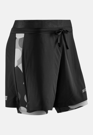 Shorts de sport noirs avec une couche de compression intérieure à motifs, taille élastique et cordon de serrage à l'avant.