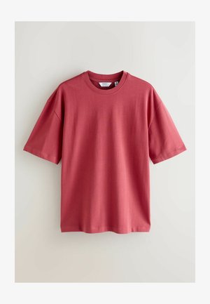 Short-sleeve t-shirt in muted rose, made from soft cotton, featuring a rounded neckline and relaxed fit, with a smooth texture and no patterns.