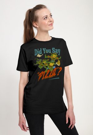 Young woman wearing black T-shirt with cartoon turtles chasing pizza slice and text "Did You Say 'Pizza?'"