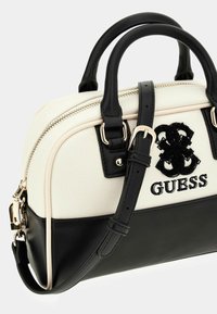 Schwarze und cremefarbene Handtasche aus Canvas und Leder, mit Reißverschluss, zwei oberen Griffen, verstellbarem Schultergurt und gesticktem Logo.