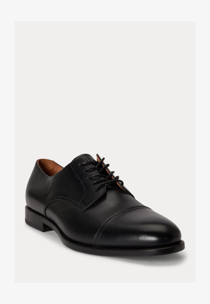 Black leather men's dress shoe with closed lacing, cap toe, and low heel on plain light background.