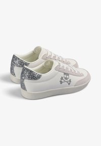 Zapatillas blancas de cuero con acentos grises y un talón gris brillante. Presentan el logotipo de calavera y huesos cruzados, cordones planos y una suela texturizada.