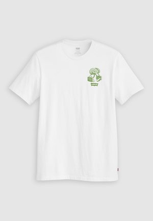 Fehér pamut póló zöld grafikai tervezéssel, amelyen egy fa és dobozok halmaza található a bal mellen. Klasszikus kerek nyakú és rövid ujjú.
