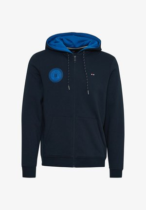 Navy huppari, jossa on sininen sisähuppu, etupuolen logo, narukoristeet ja kaksi etutaskua. Sisältää ribbireunat hihoissa ja helmassa.