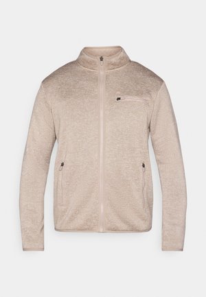 Beige fleecetröja med hög krage, hel dragkedja, två sidofickor och en bröstficka. Mjuk textur med ett subtilt mönster.