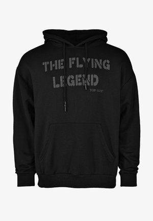 Musta huppari, joka on valmistettu puuvillasekoitteesta ja jossa on etupuolella kenguru-tasku. Teksti "LENTÄVÄ LEGEND" ja "TOP GUN" on painettu rohkealla, erottuvalla tyylillä.