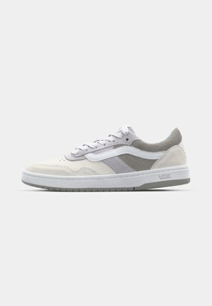 Sneaker with a white and light gray suede upper, featuring a sleek design, flat laces, and a white rubber sole with textured grip.