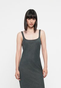Dark gray sleeveless dress with a square neckline, featuring textured stitching along the straps and a fitted silhouette.