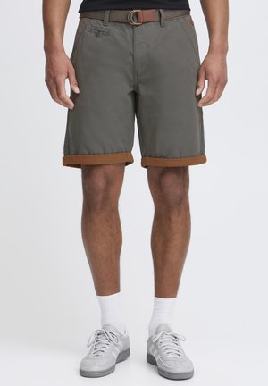 Olive green shorts with brown folded cuffs, made from lightweight fabric. Features a front button, pockets, and a brown belt with a circular buckle.