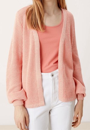Pink knitted cardigan with a relaxed fit, featuring a V-neck, long sleeves, and ribbed cuffs, worn over a light pink tank top.