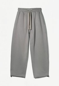 Graue Jogginghosen aus weichem Stoff, mit einem elastischen Bund und Kordelzug, seitlichen Taschen und Reißverschlüssen an den Knöchelbündchen.