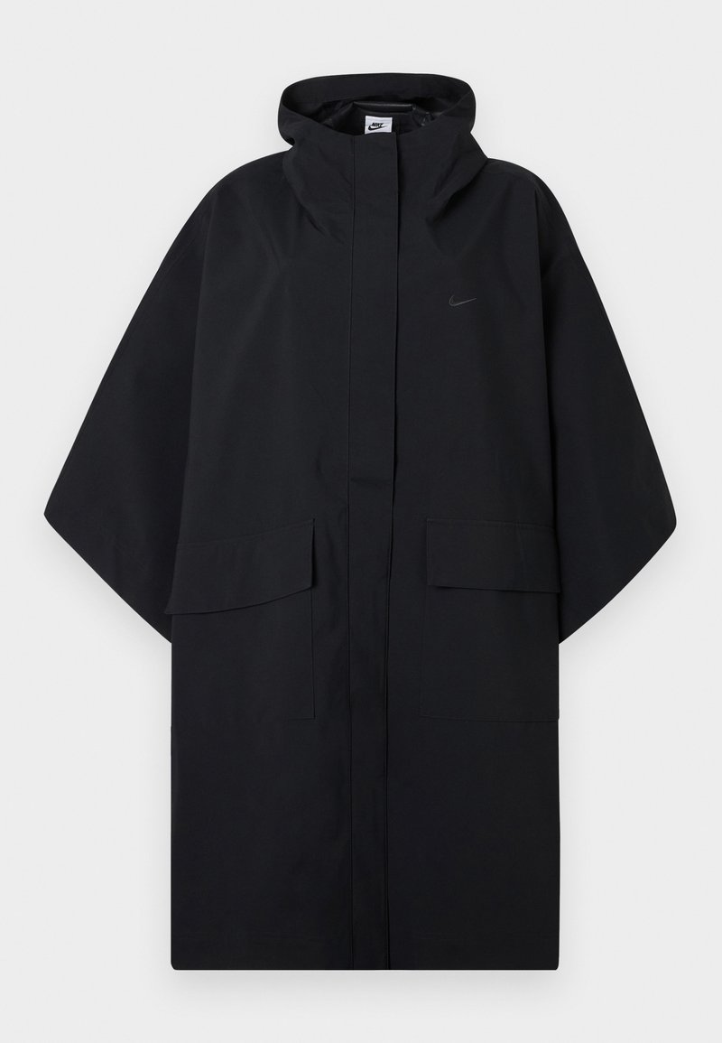 Black Nike rain poncho with hood, front velcro closure, two flap pockets, and loose, wide sleeves.