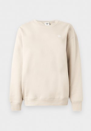 Beżowa bluza z okrągłym dekoltem i długimi rękawami, ściągacze przy mankietach i u dołu, z małym białym logo Adidas trefoil na lewej piersi.