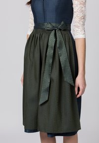 Traditional dress with a blue bodice and green pleated skirt. Skirt features a patterned texture and a satin bow at the waist.