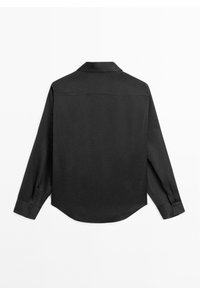 Black long-sleeve shirt made of smooth fabric, featuring a classic collar, curved hem, and buttoned cuffs. No visible patterns or accents.