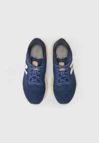 Blue mesh running shoes with beige accents, round toes, and classic lace-up design. Textured surface and padded insoles visible.