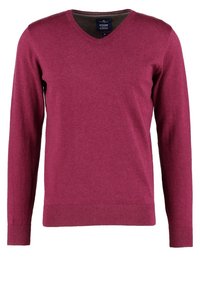 Pull en col en V couleur bordeaux, fabriqué en maille texturée. Comprend des manches longues ainsi que des poignets et un ourlet côtelés pour une coupe ajustée.