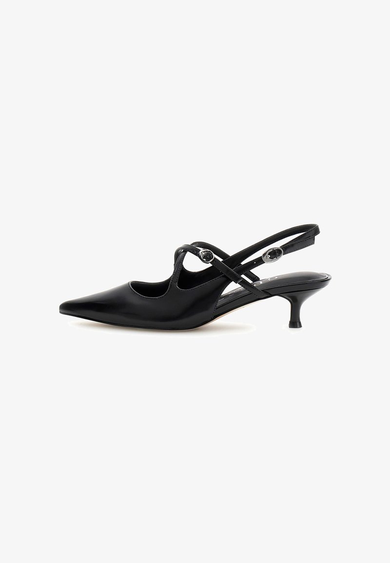 Escarpin slingback noir en cuir verni avec talon kitten, bout pointu et deux fines lanières croisées à la cheville avec boucles argentées.