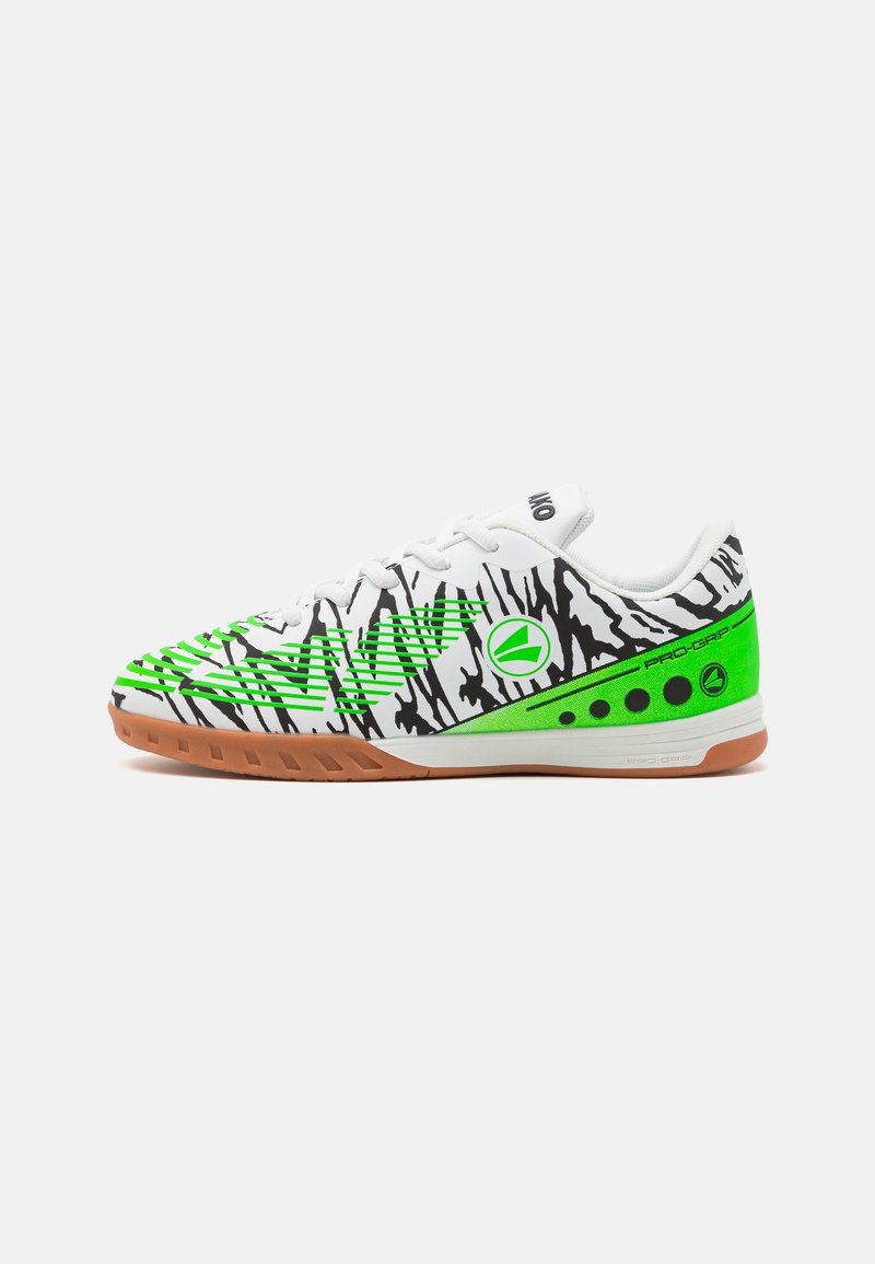 Footwear featuring a white base with black tiger stripe pattern, vibrant green accents, and a gum rubber sole for traction and grip.