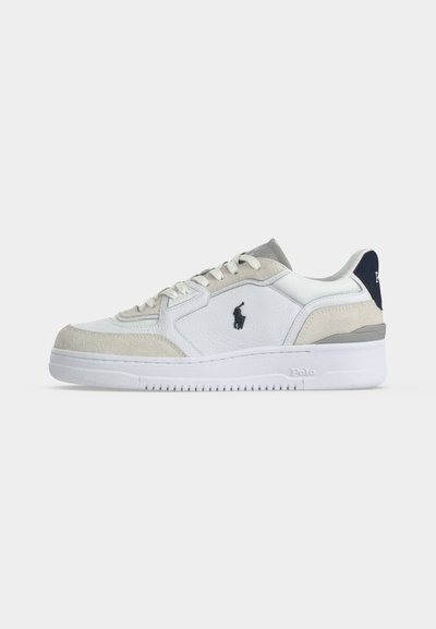 Hvit og beige lav sneaker med hvit såle, svart Polo-logo på siden og marineblå hælflik med merkenavn.