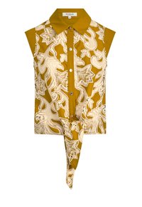 Mouwloze mosterdblouse met een ingewikkeld wit bloemenkantpatroon, knopen aan de voorkant en een knoopdetail aan de zoom. Katoenen stof.