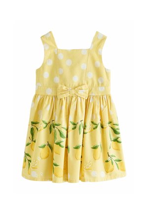 Geltona rankovių neturinti suknelė su baltais taškeliais, sijone citrinos ir lapų raštas bei kaspinas juosmens srityje.