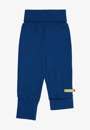 Navy blue cotton pants with a wide waistband, tapered ankles, and a small multicolored brand tag on the side. Soft texture, casual design.