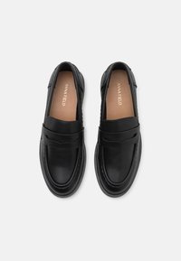 Black leather loafers with a smooth finish, including a decorative strap across the vamp and stitching details along the edges.