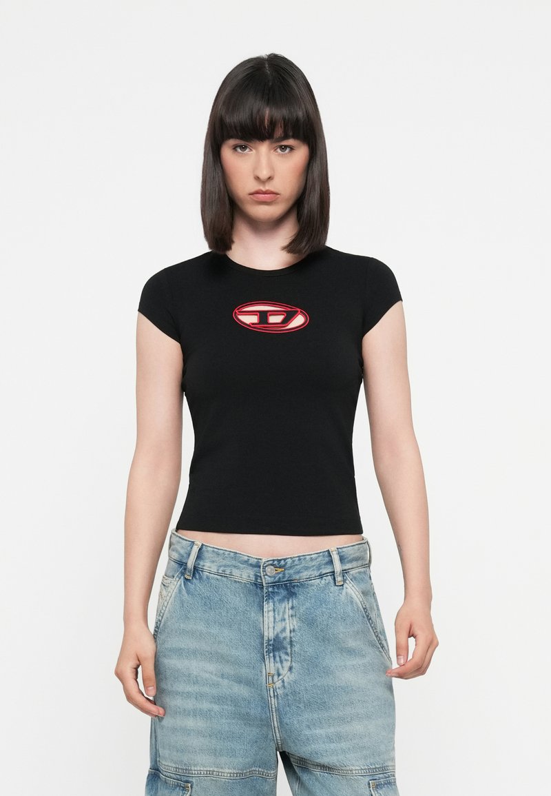 Black fitted t-shirt with short sleeves, featuring a red oval logo at the chest, paired with light blue denim shorts, visible buttons and pockets.