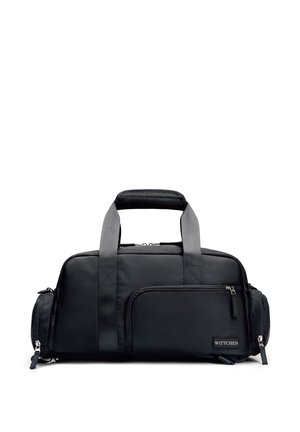 Zwarte rechthoekige reistas met twee stevige handvatten, een voorvak met rits, zijvakken en een "WITTCHEN" merklabel in de rechterbenedenhoek.